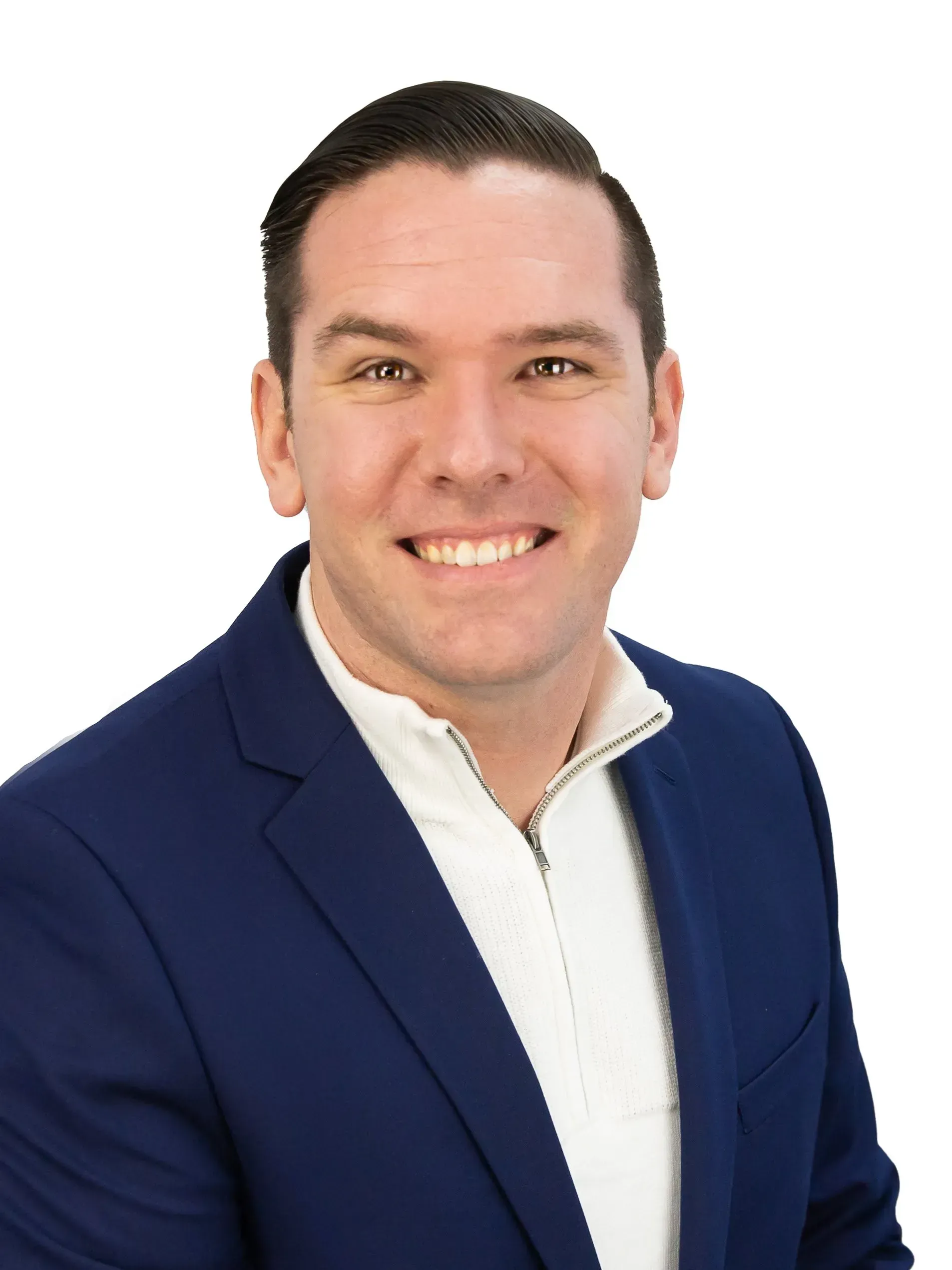 A man in a blue suit and white shirt is smiling for the camera.