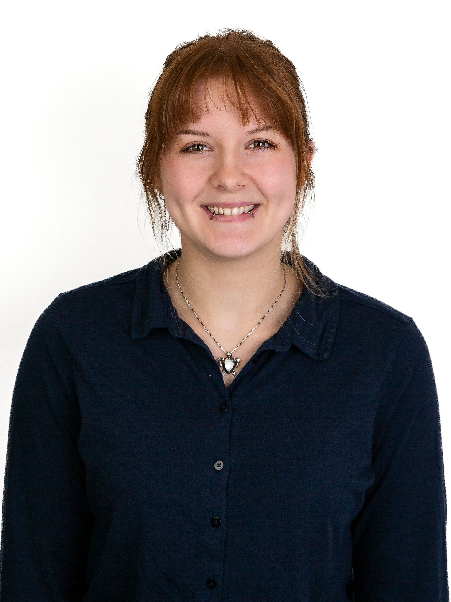 A young woman with red hair and wearing a black shirt