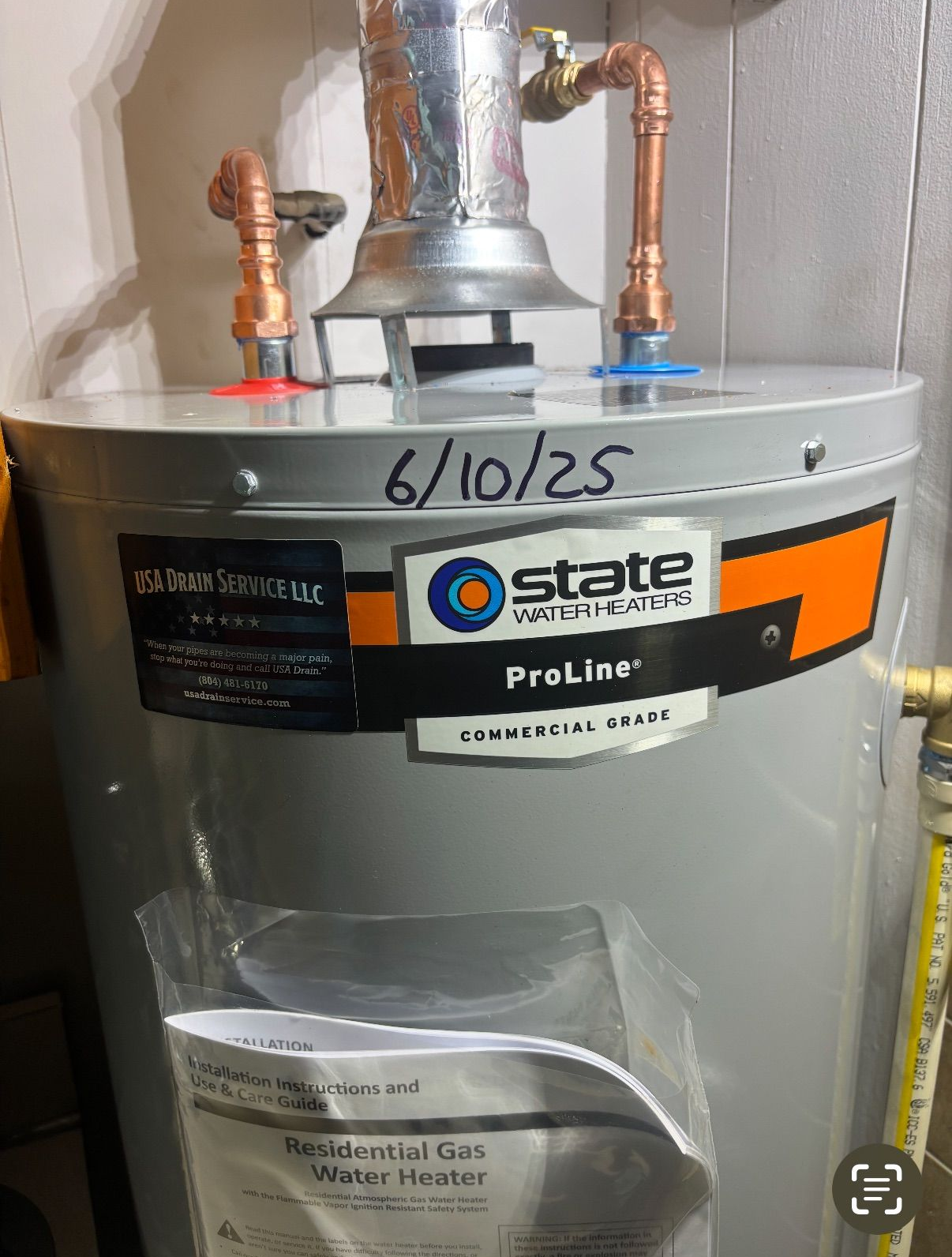 White water heater and two wall-mounted boilers in a utility room.