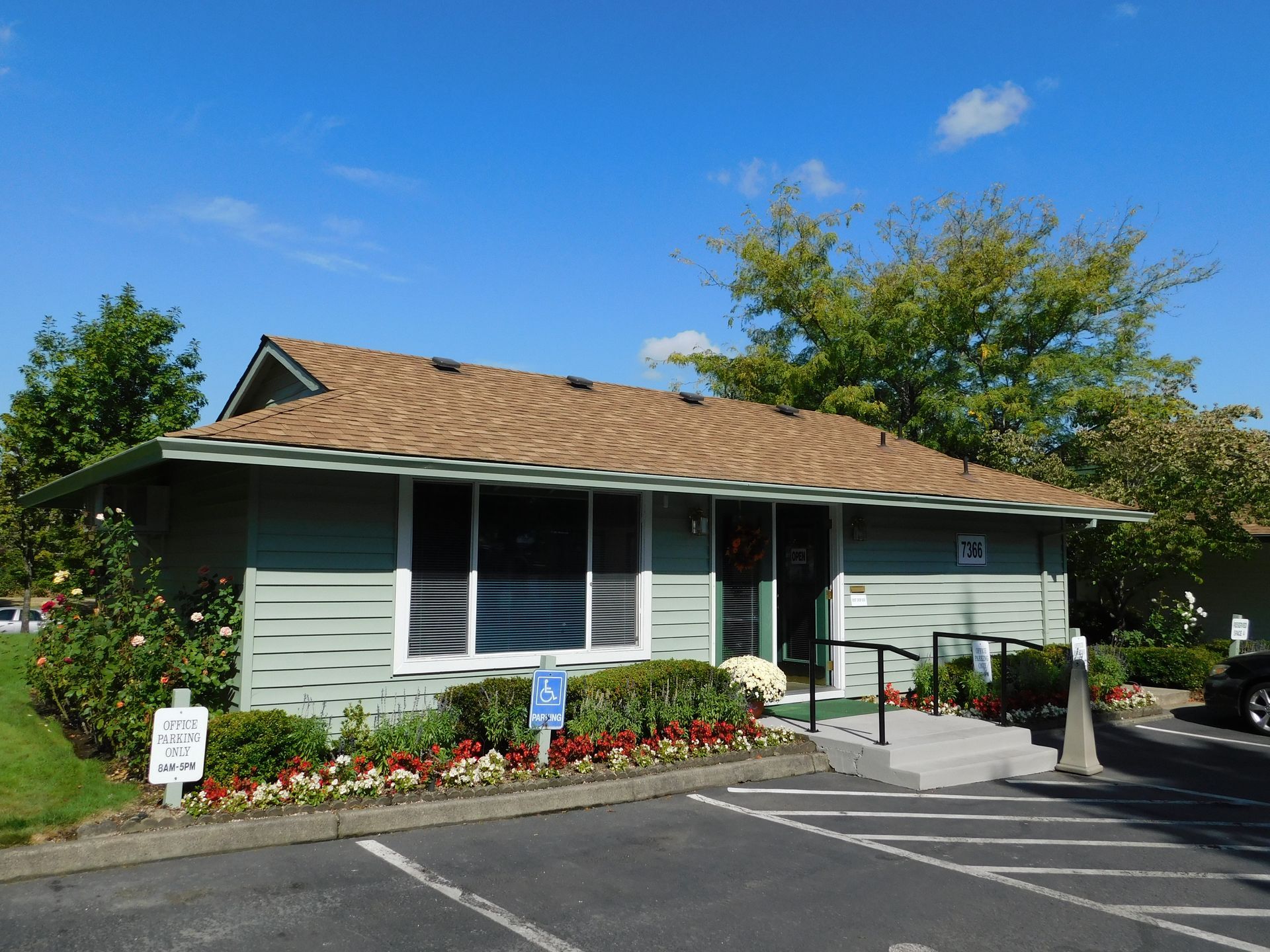 Green building with ramp and accessible parking.