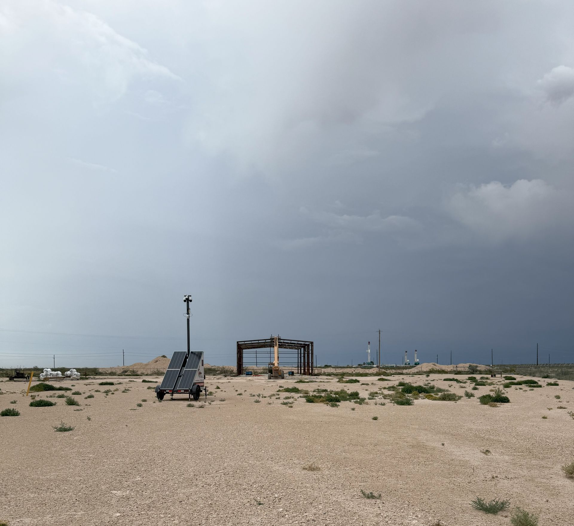 A desert landscape with a cloudy sky in the background