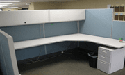 White cubicle with cupboards and cabinet