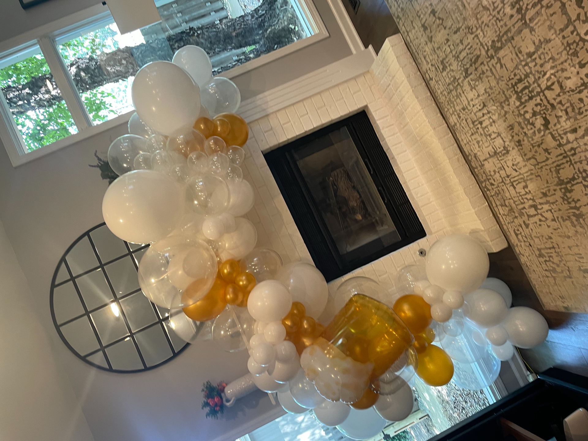 A living room filled with balloons and a fireplace.