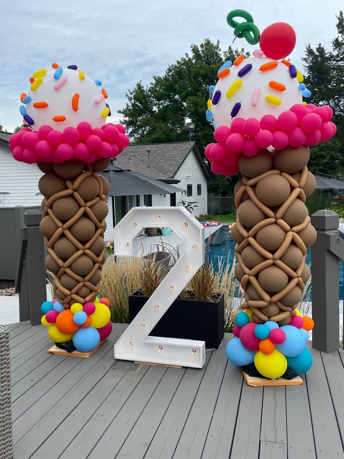 Two ice cream cones made out of balloons and a number 2