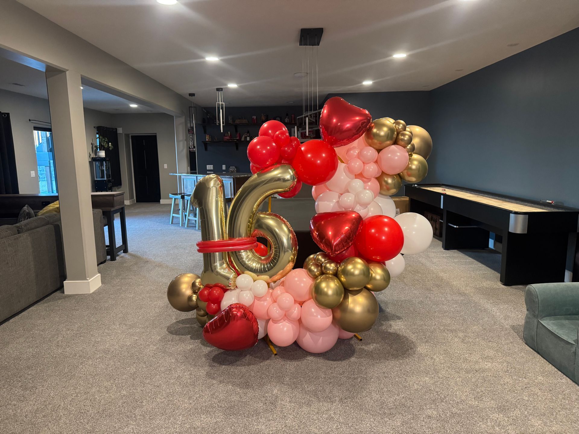 A bunch of balloons are sitting on the floor in a room.