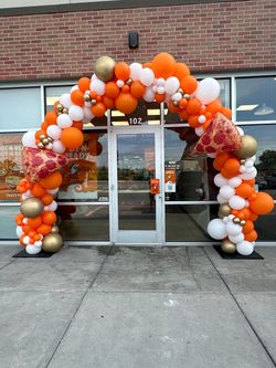 A brick building with a balloon arch in front of it