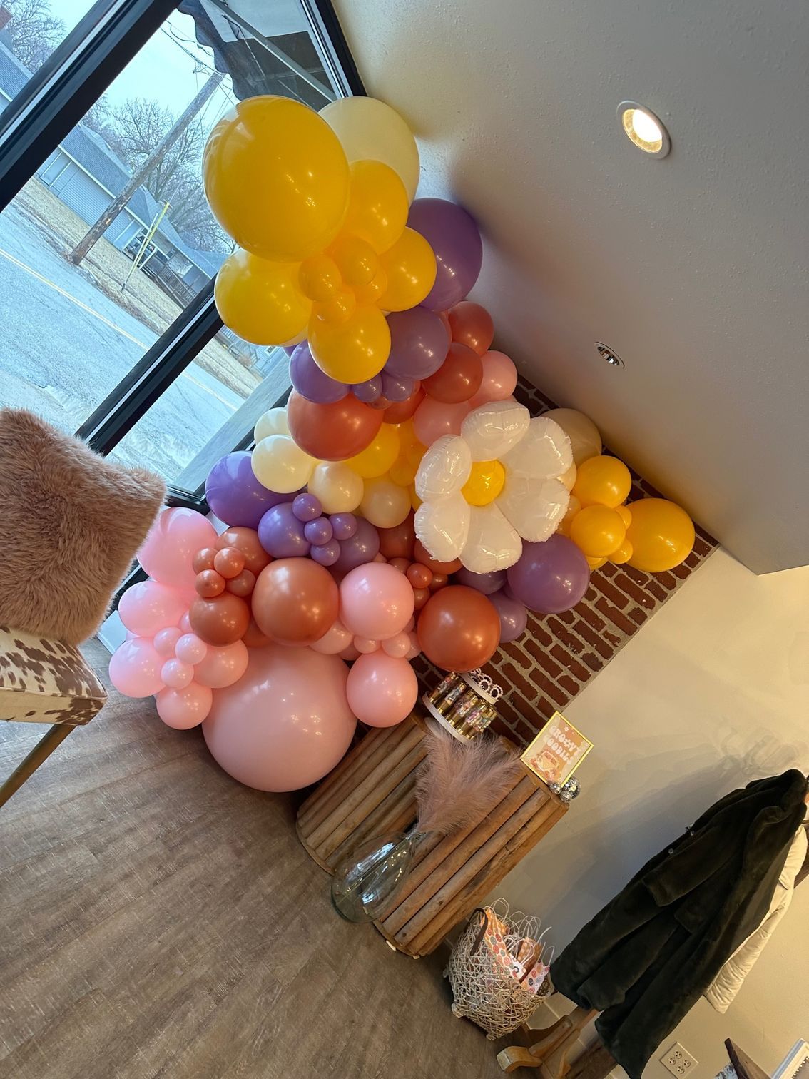 A bunch of balloons are hanging from the ceiling in a room.