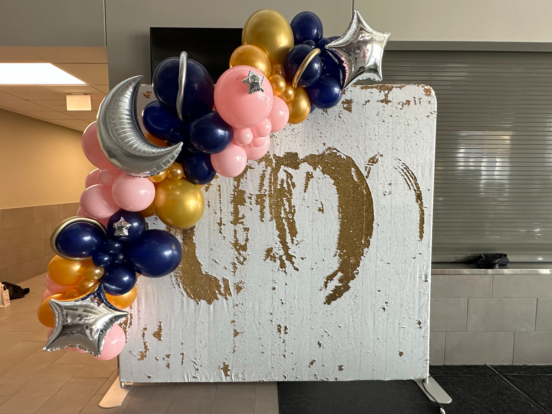 A bunch of balloons are hanging on a wall.