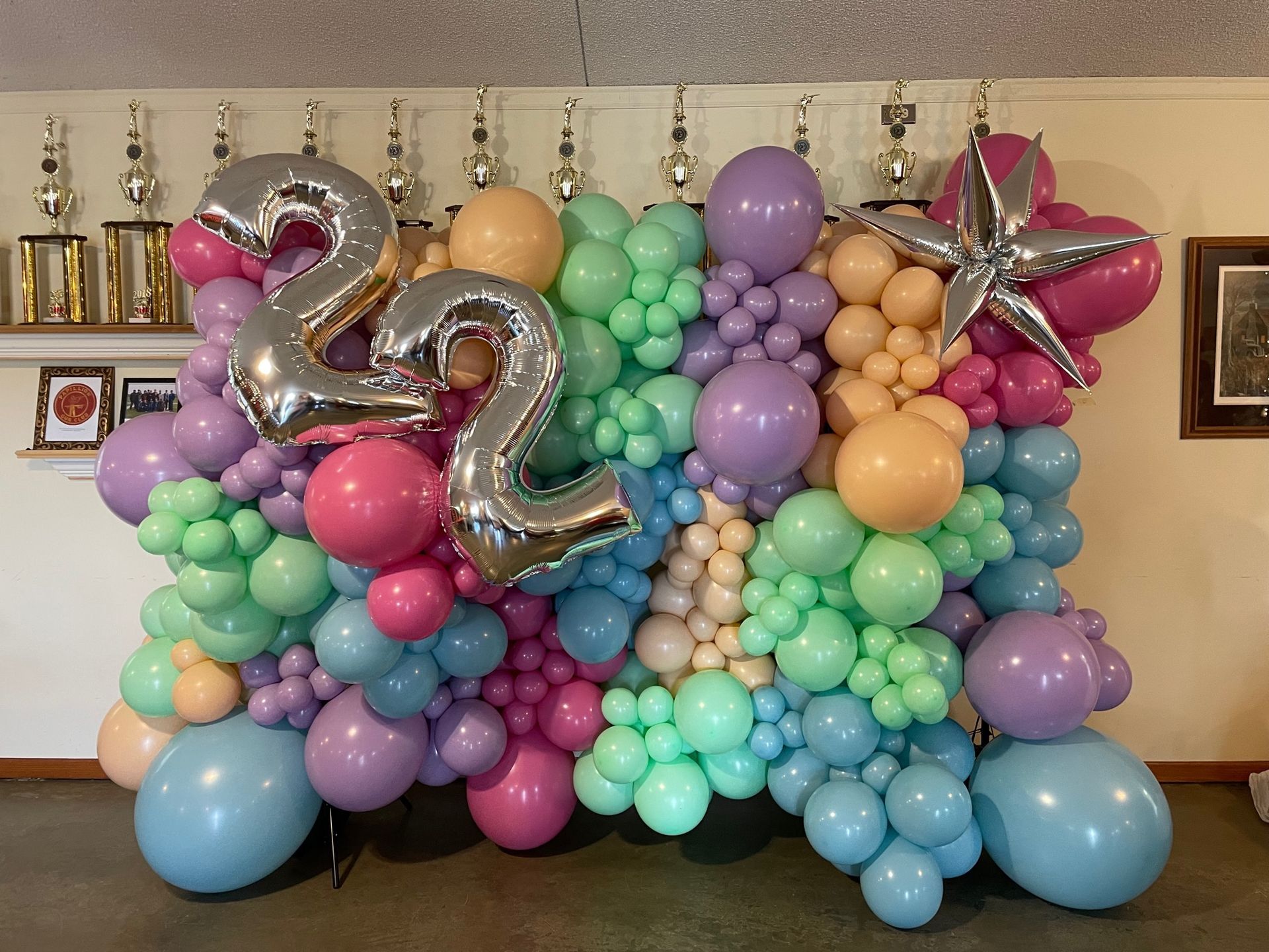 A wall of balloons with the number 22 on it