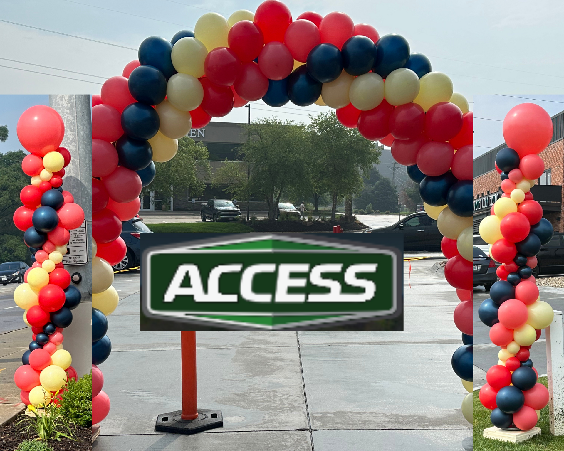 A sign that says access is surrounded by balloons