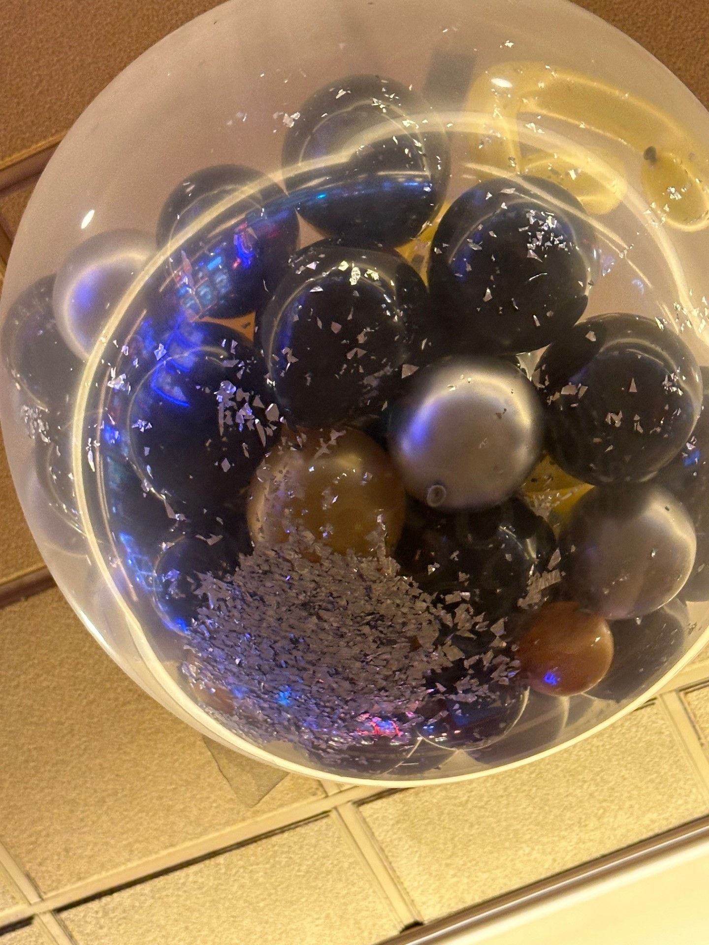 A balloon filled with marbles is hanging from the ceiling.