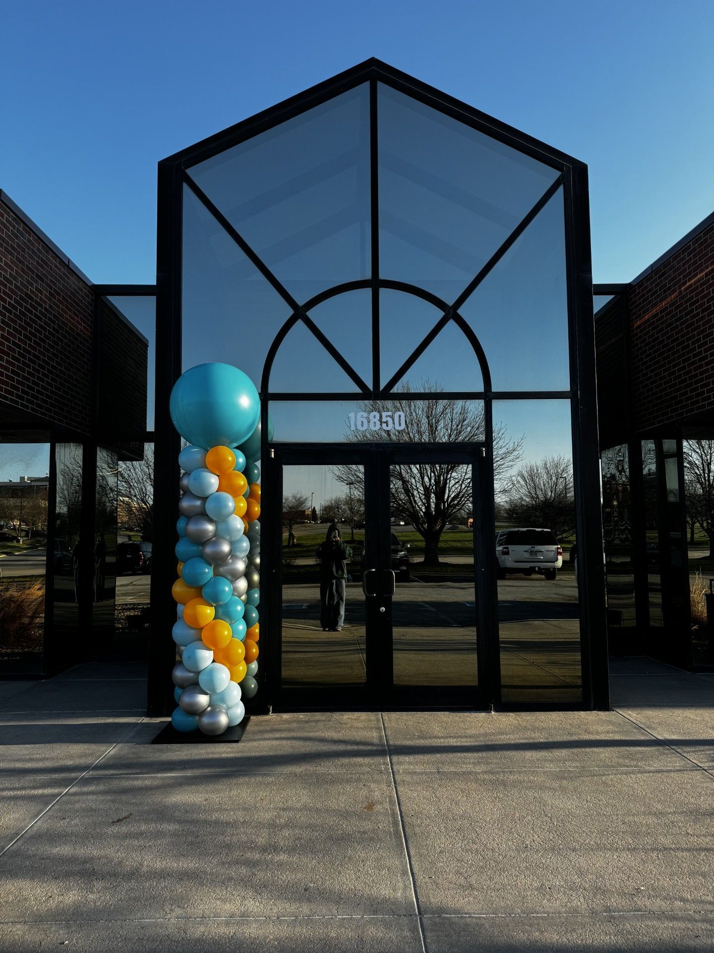 A large building with a balloon display in front of it