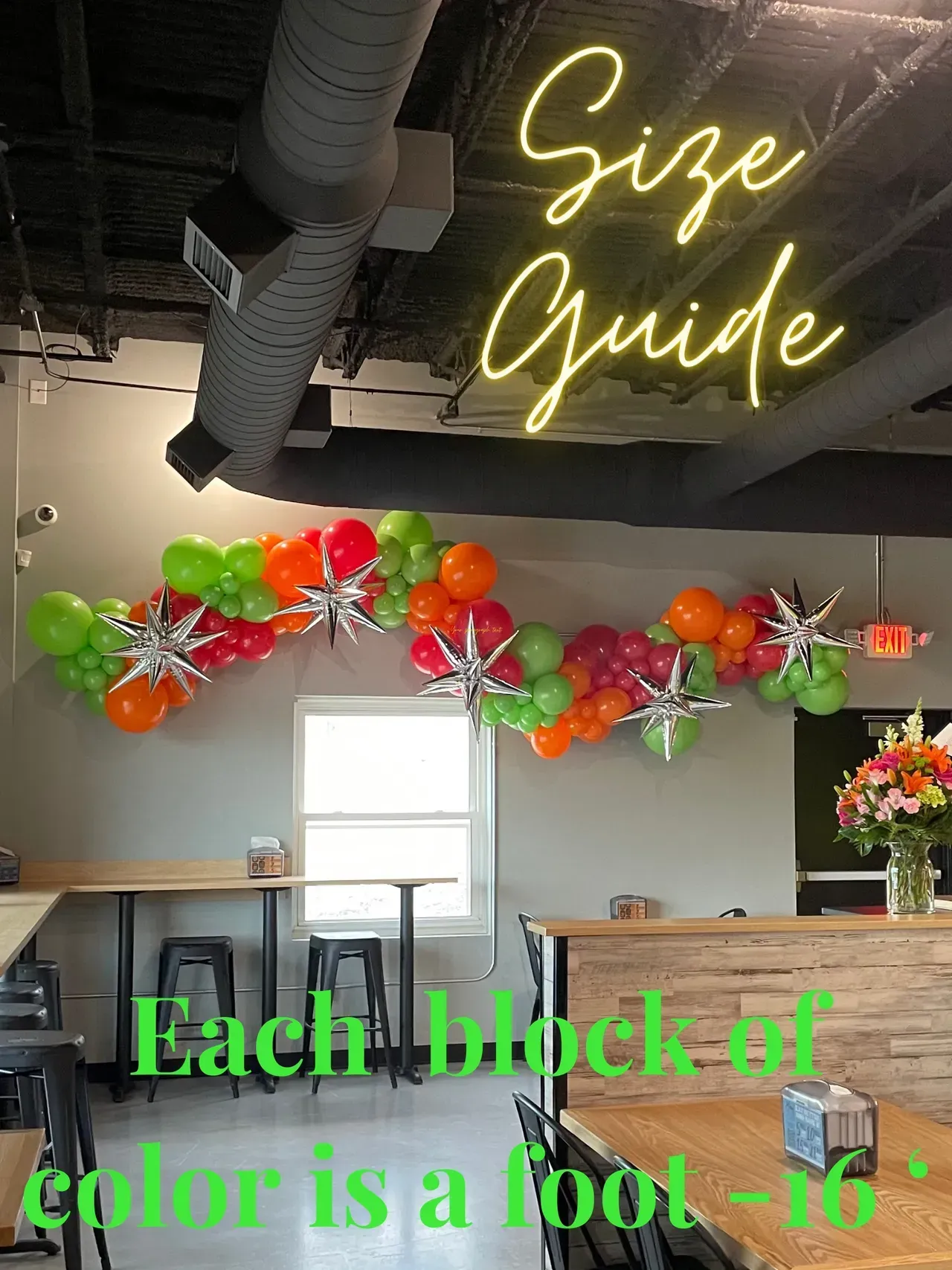 A restaurant with tables and chairs and balloons on the wall.
