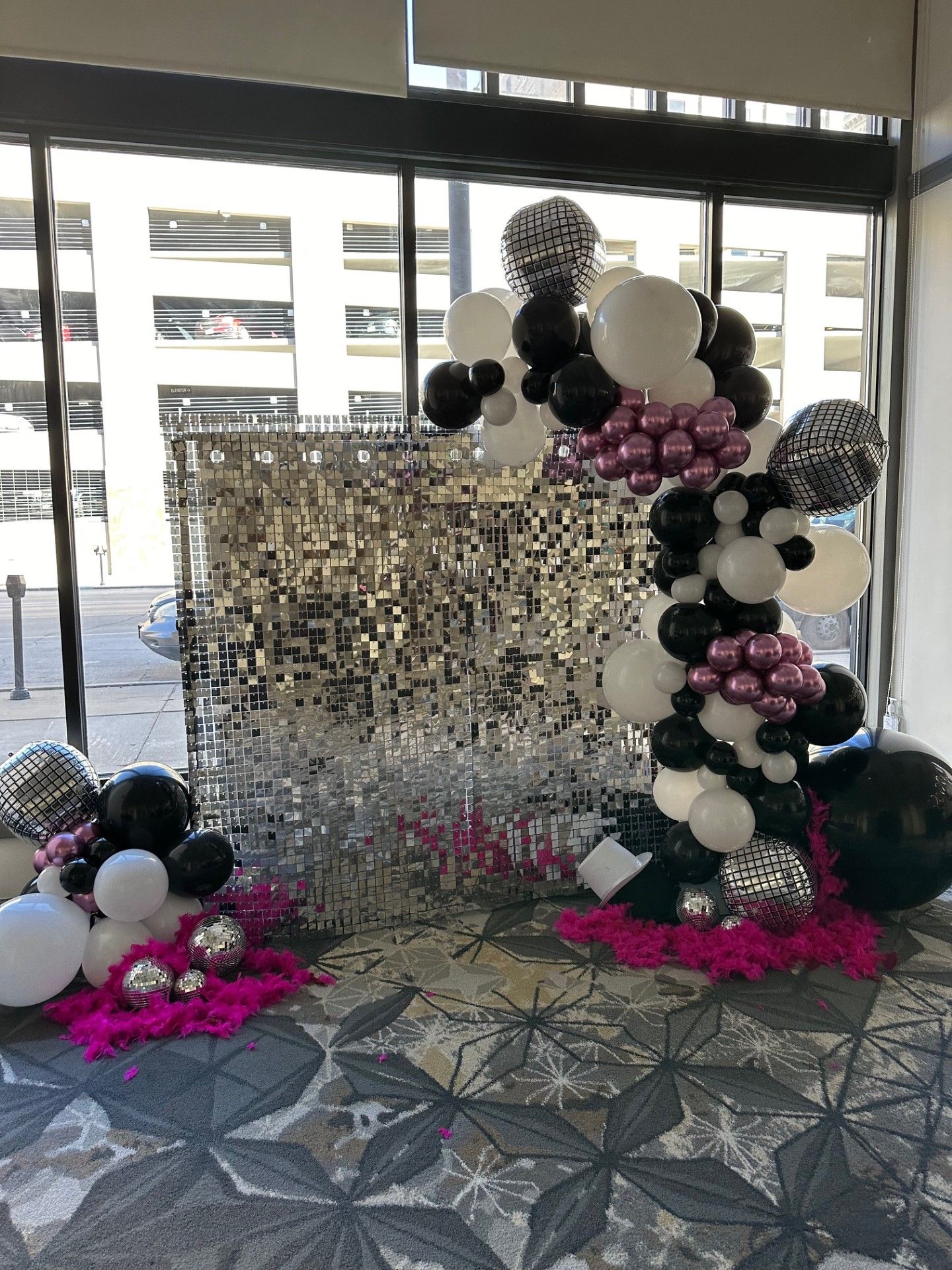 A room filled with balloons and a shimmering wall.