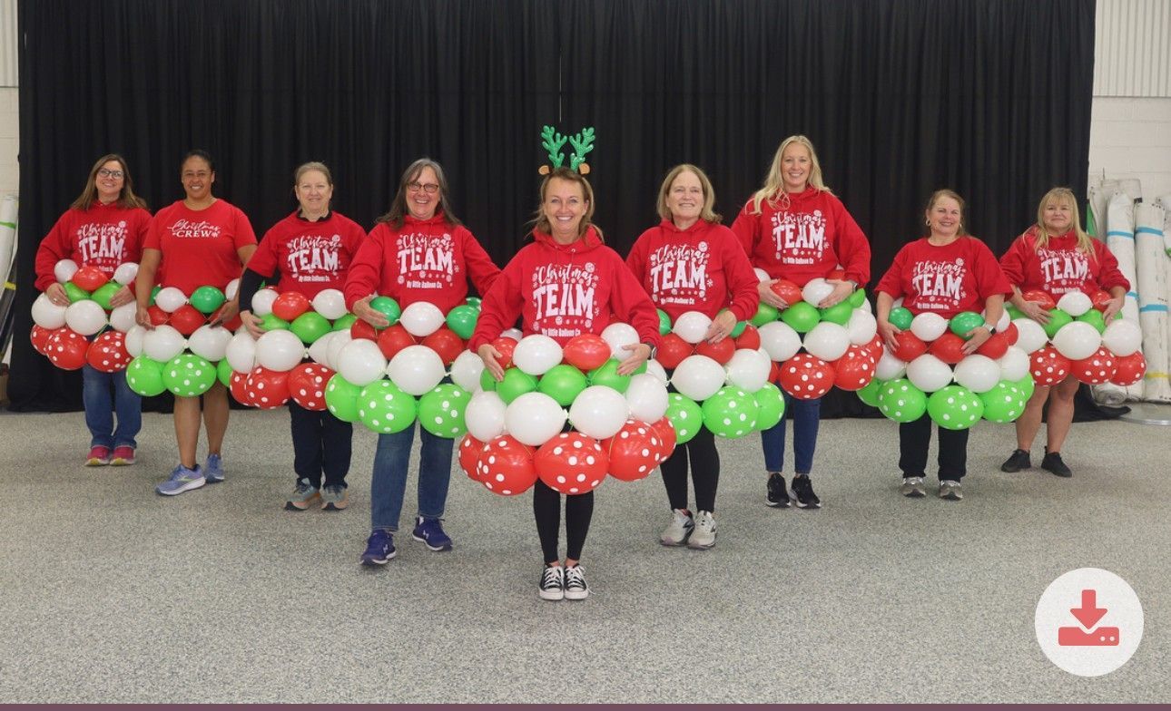 A group of people standing next to each other holding balloons.