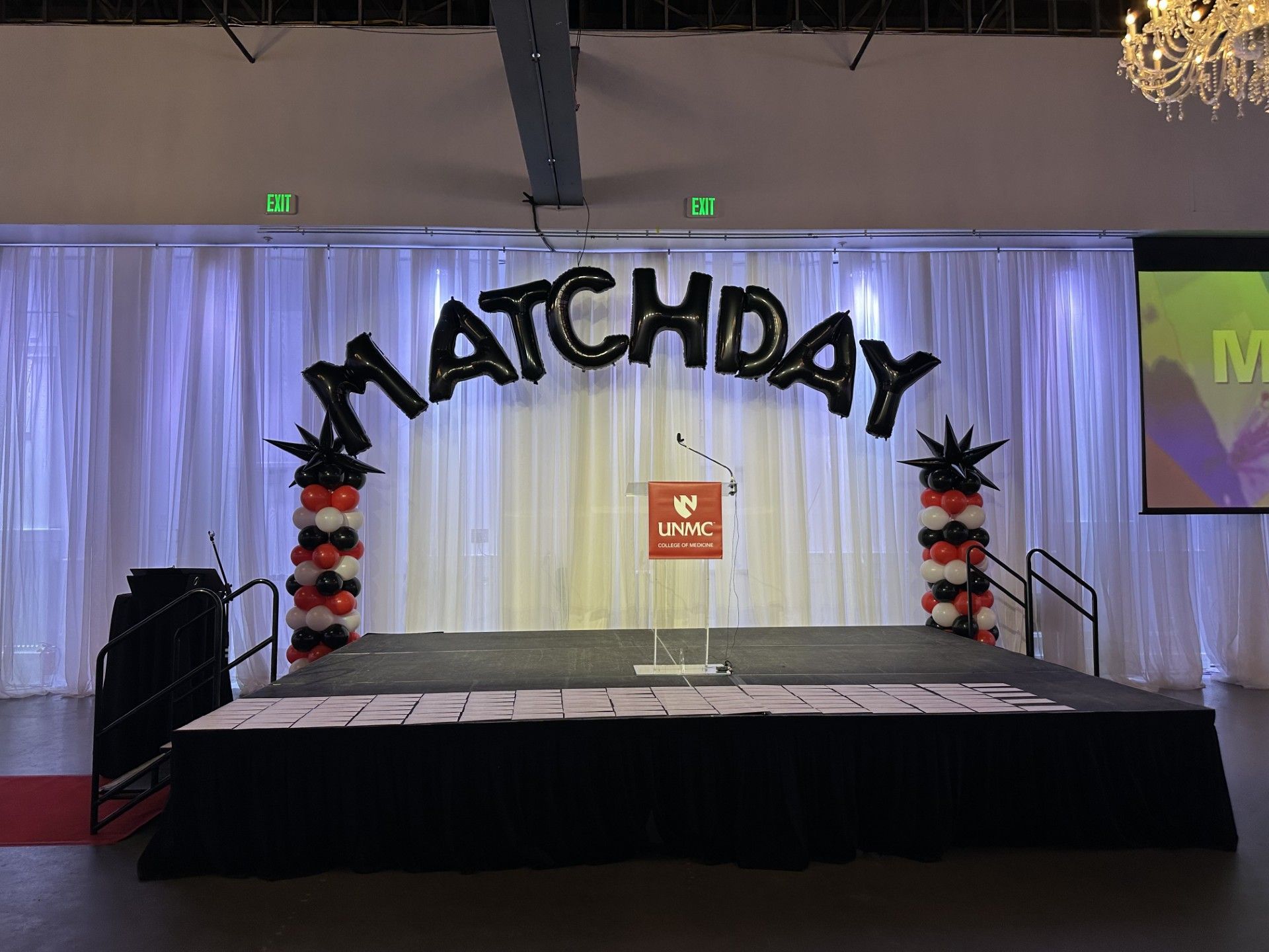 A stage with balloons and a sign that says matchday on it.