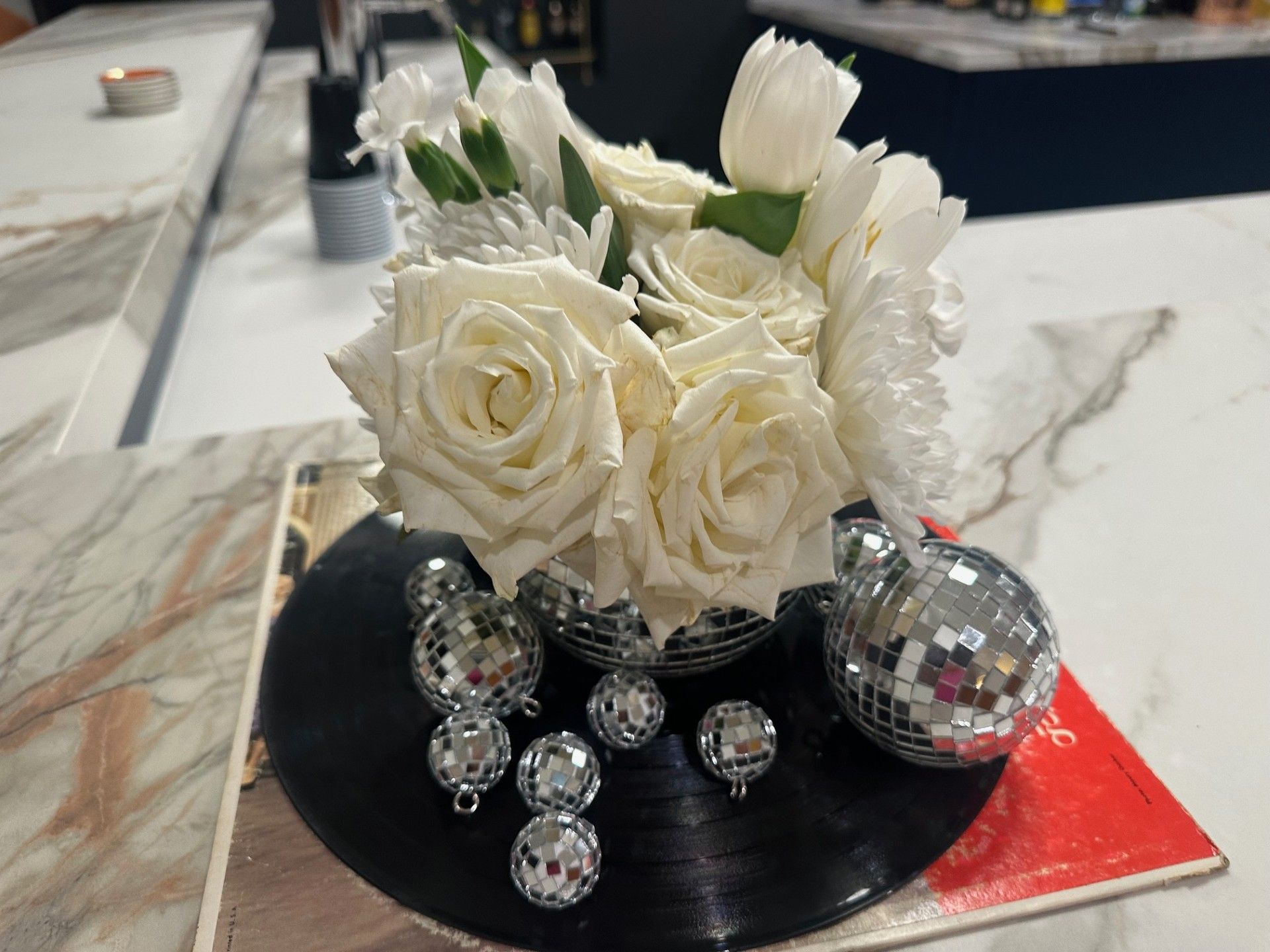 A sign that says omavols is surrounded by balloons