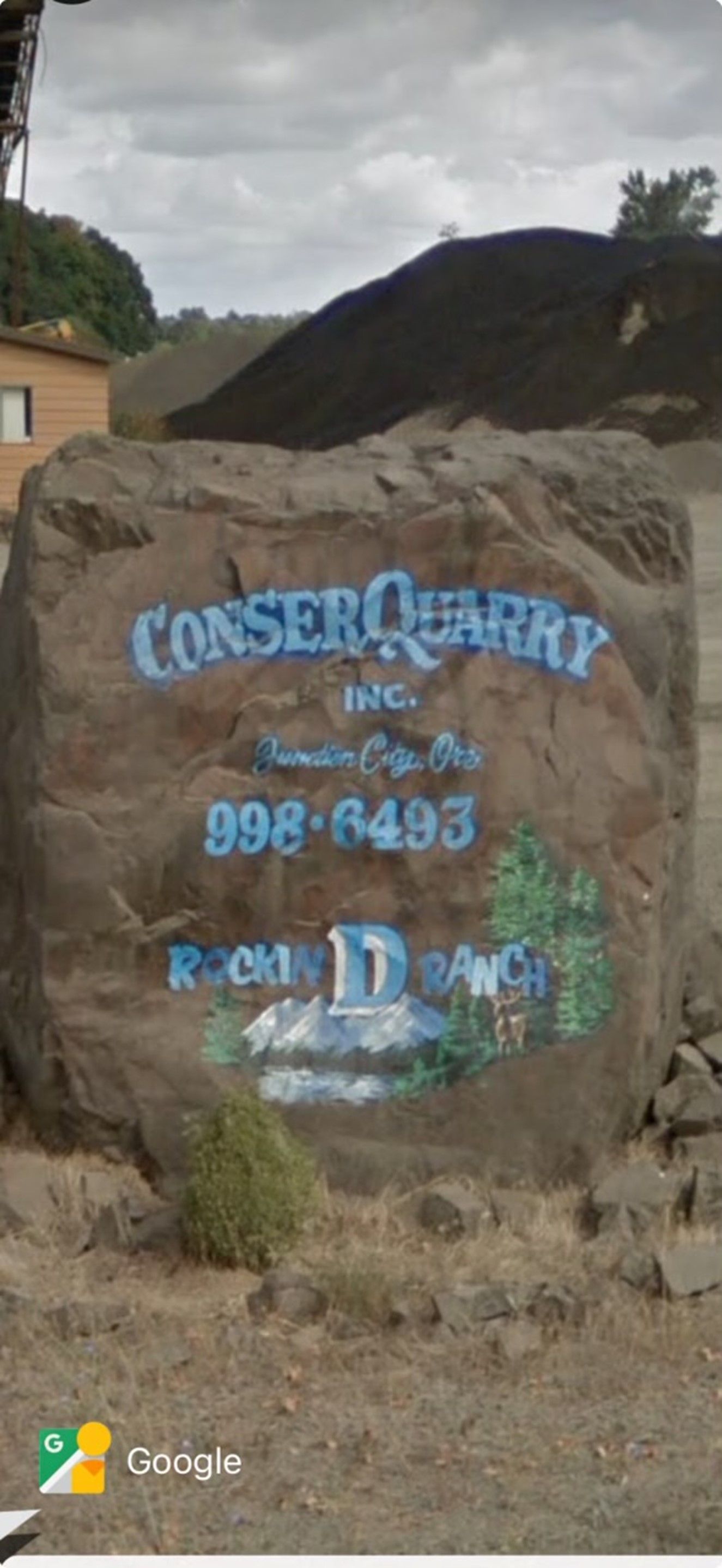 A large rock with the word Conser Quarry painted on it