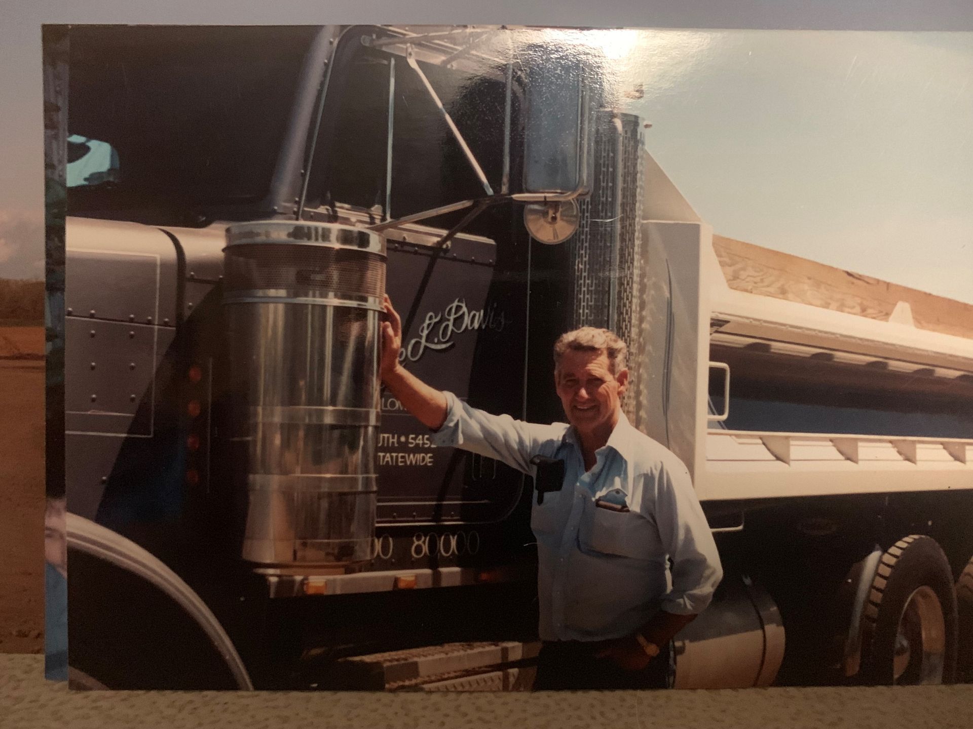 A man standing in front of a truck
