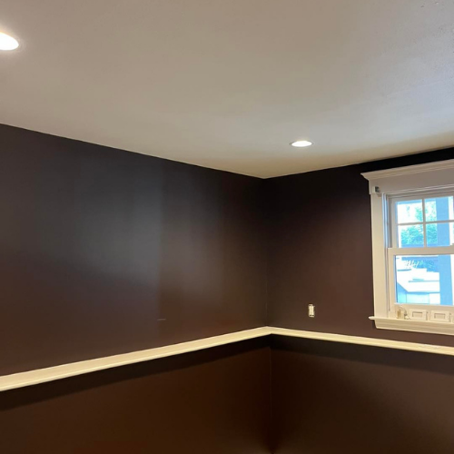 An empty room with brown walls and a window