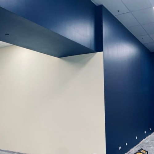 A room with a blue wall and a white wall