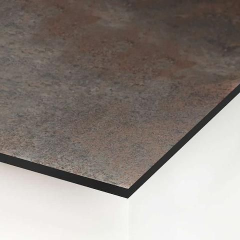 Close-up of a metal-textured panel with a black border, set against a white wall.