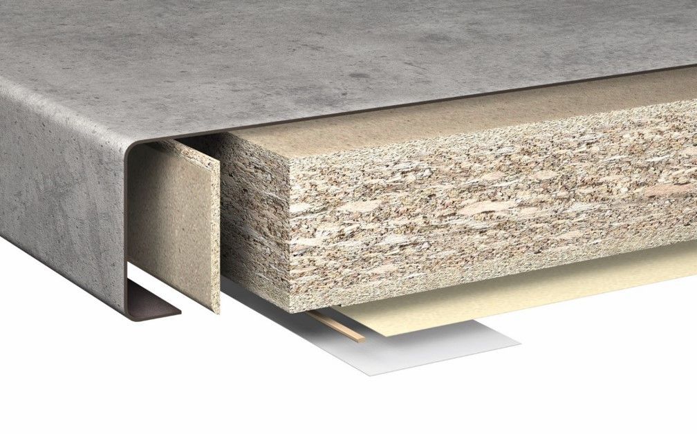 Cross-section of layered building material: concrete, particleboard, and other layers, with a metal edge.