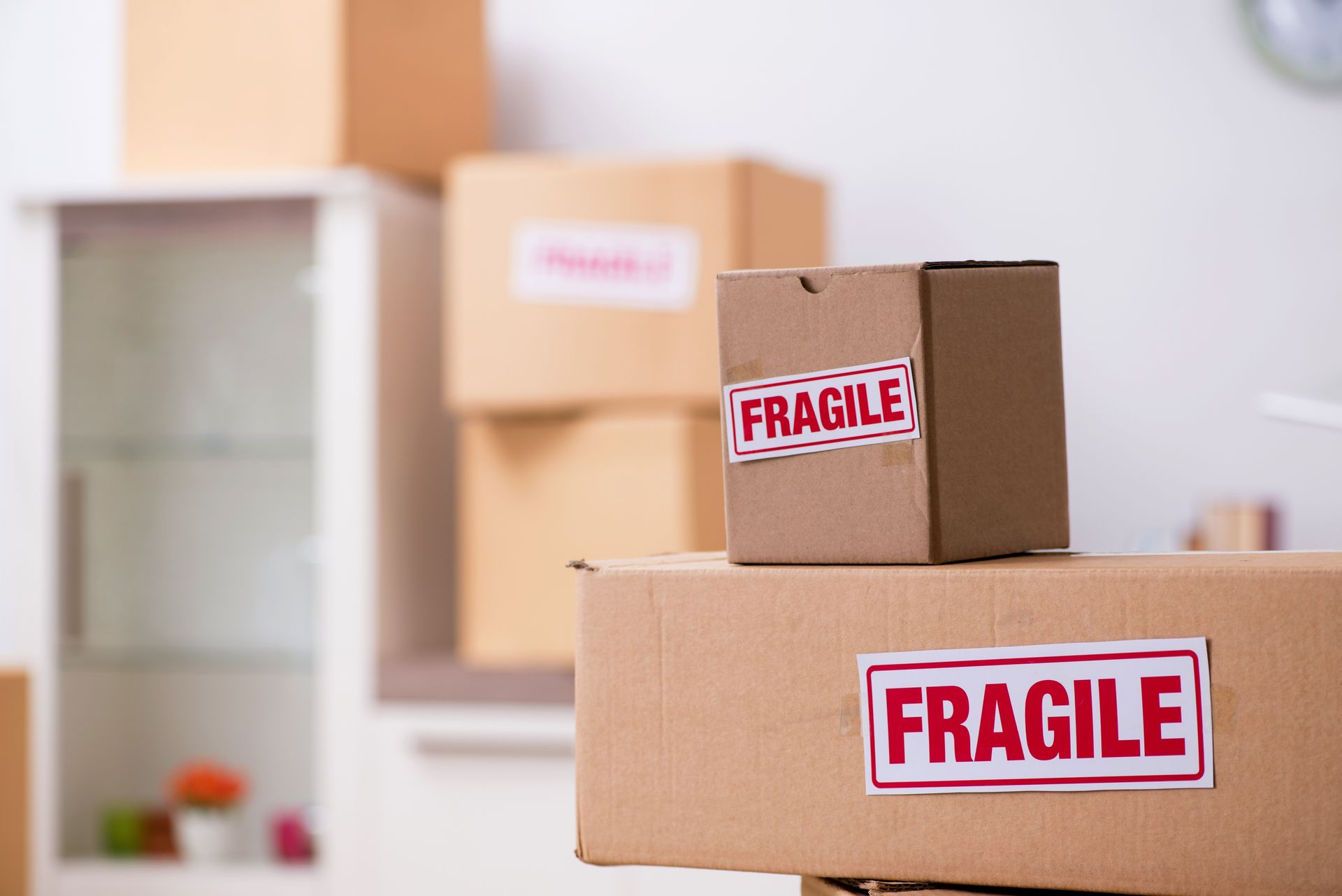A stack of cardboard boxes with fragile stickers on them