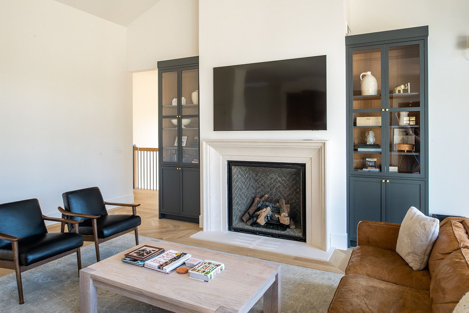 a living room with a fireplace , couch , chairs and a flat screen tv .