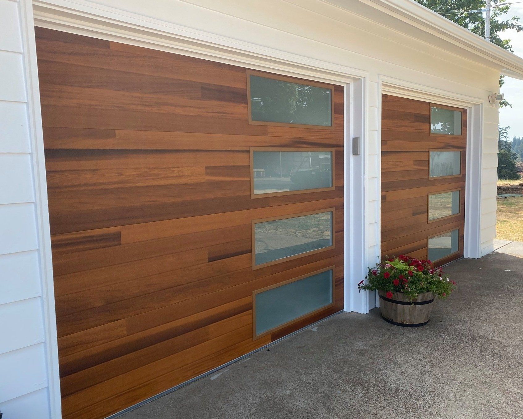 The garage doors are made of wood and glass.