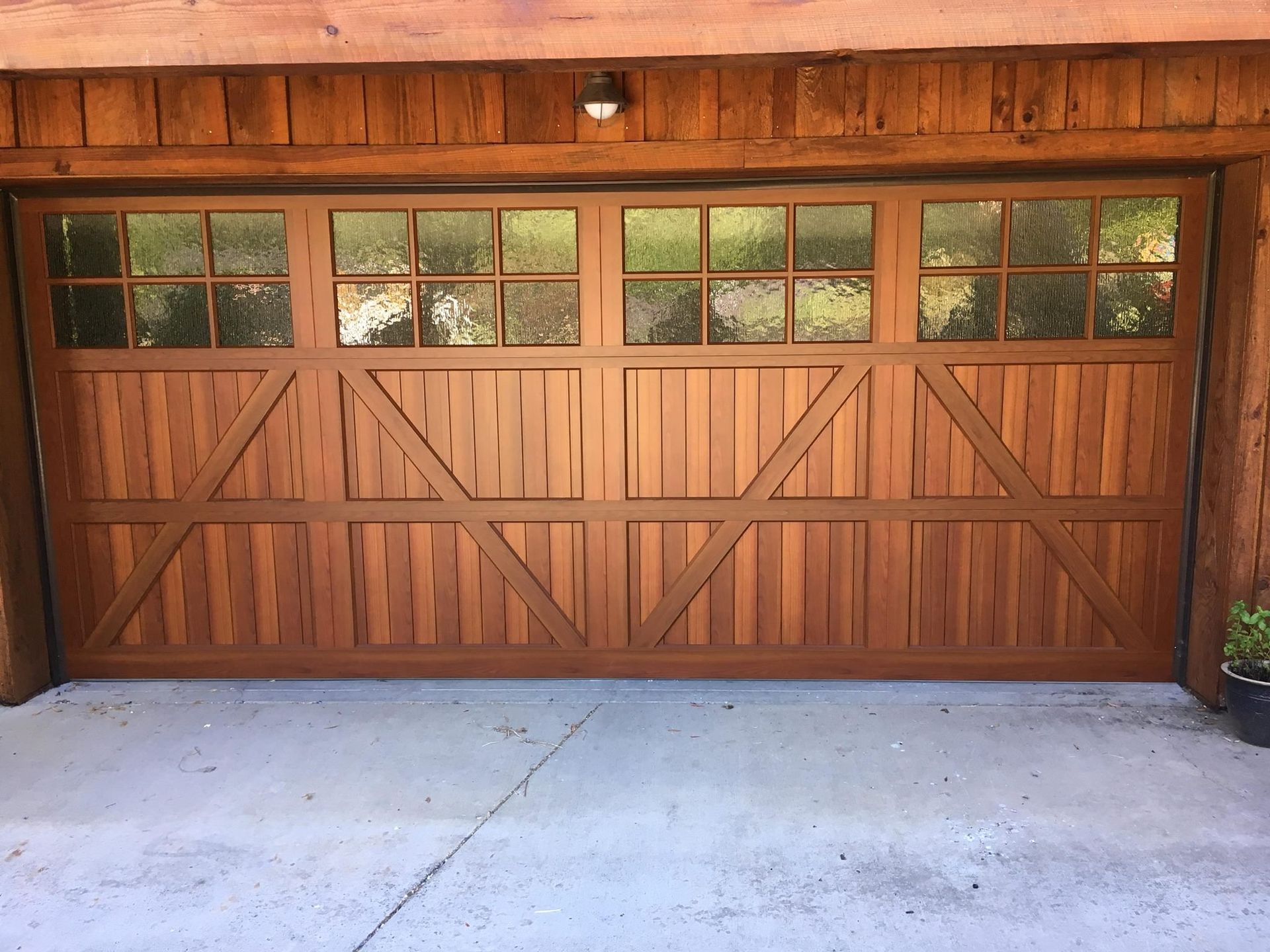 A wooden garage door with a lot of windows
