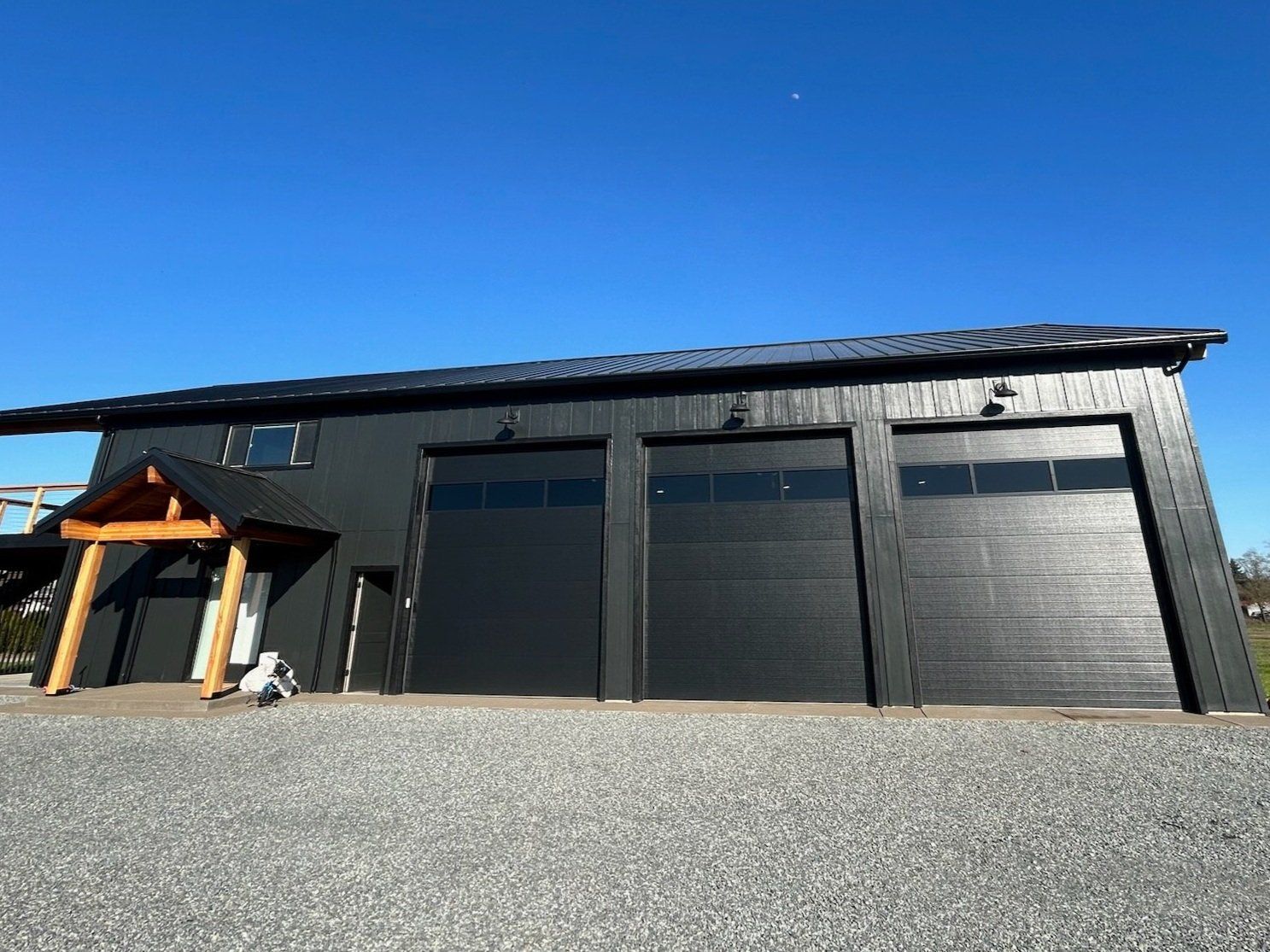 A large black building with a lot of garage doors