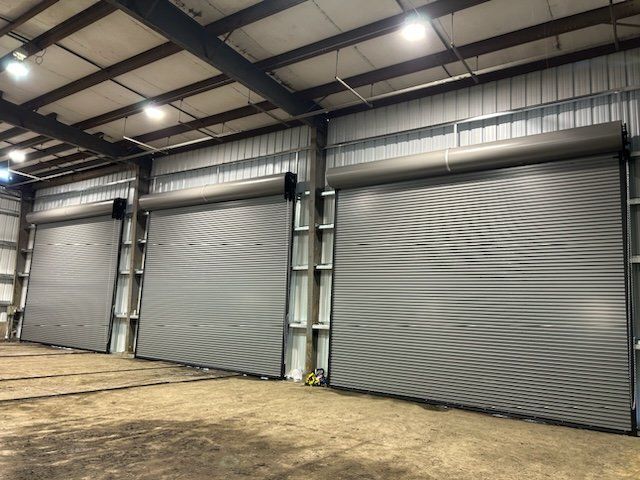 A row of garage doors in a large building.