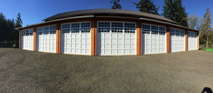 A large garage with a lot of white garage doors.