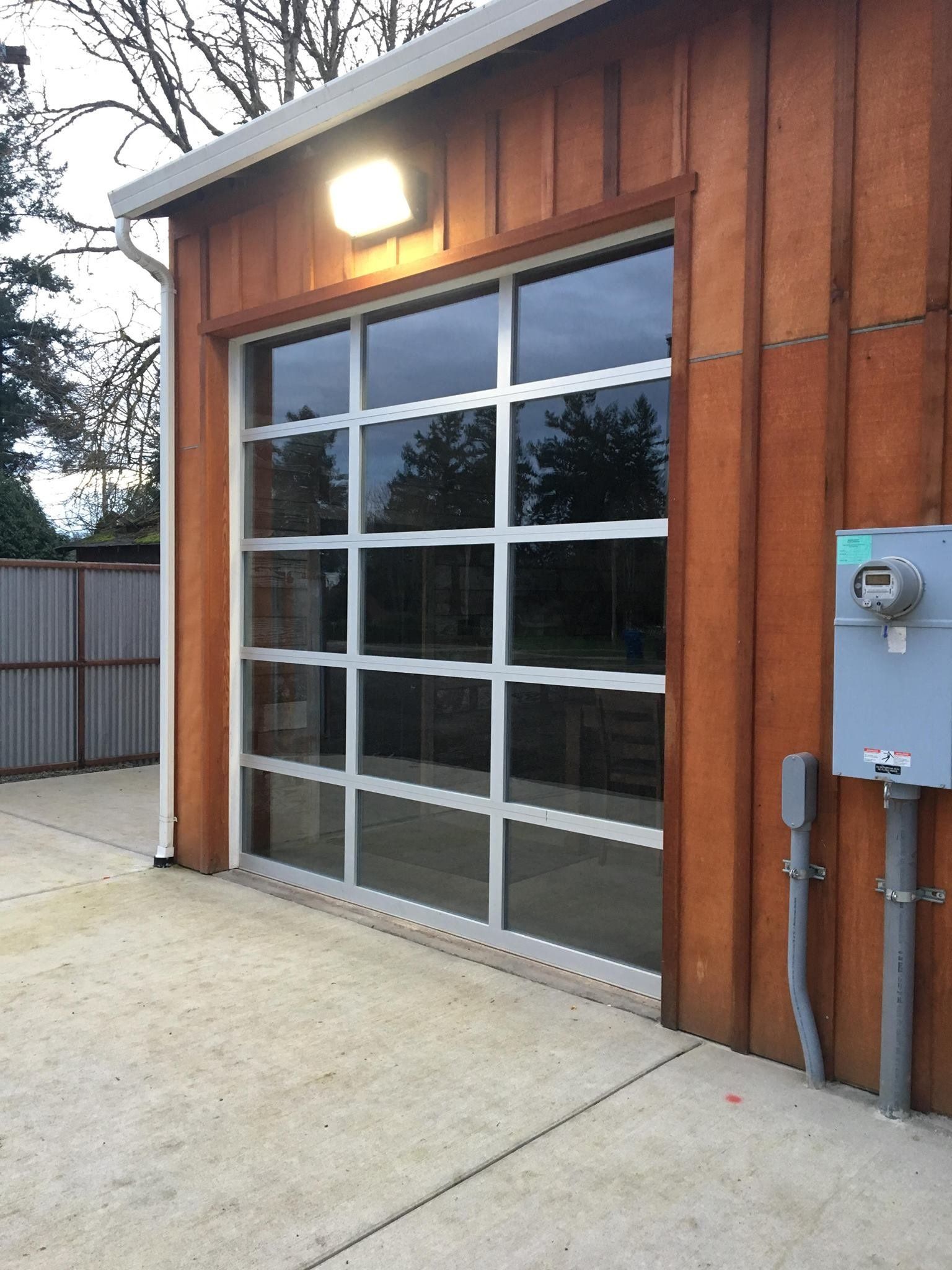 A garage door with a lot of windows and a light on it