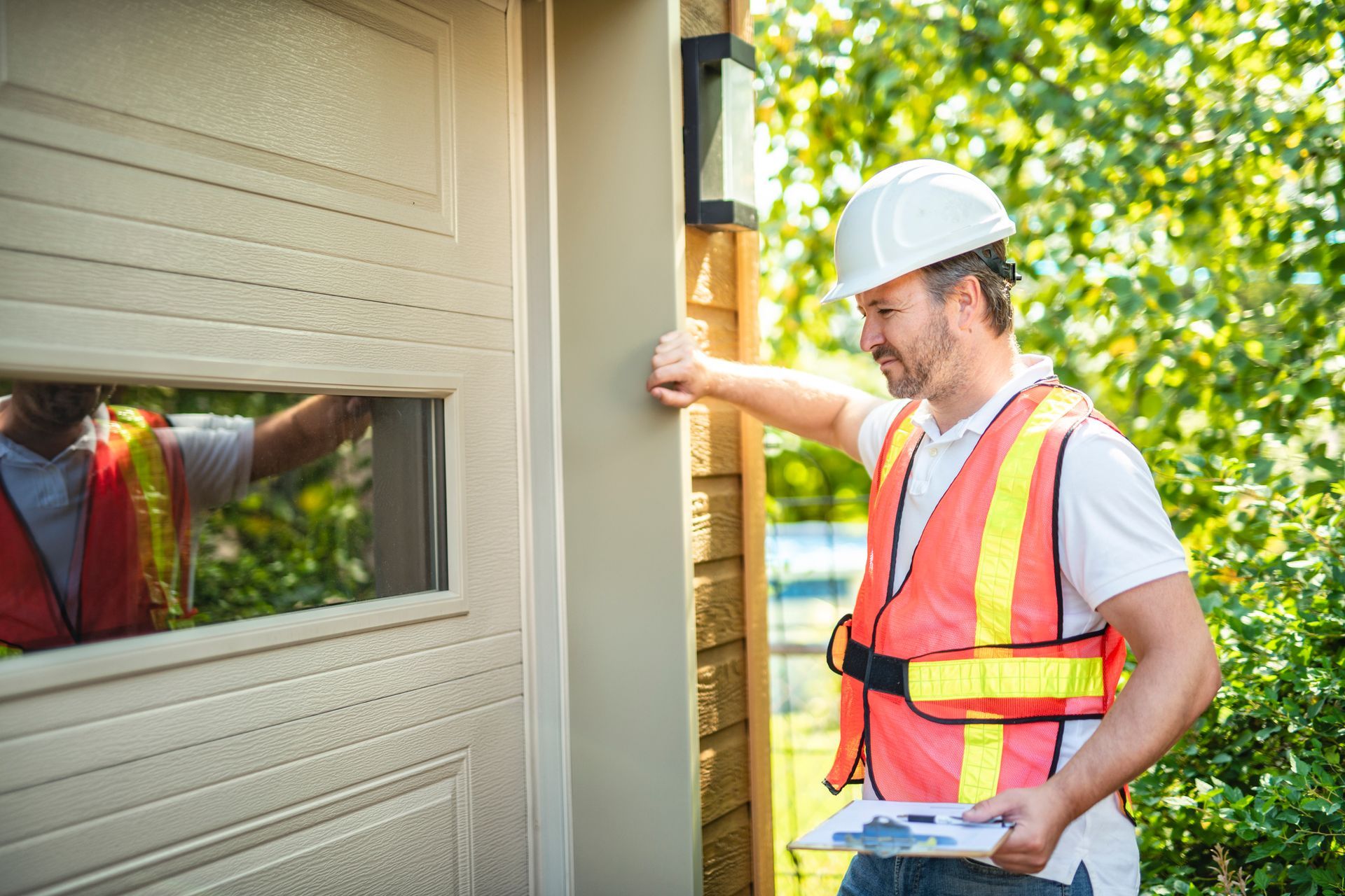 A technician is inspecting a residential garage door repair.