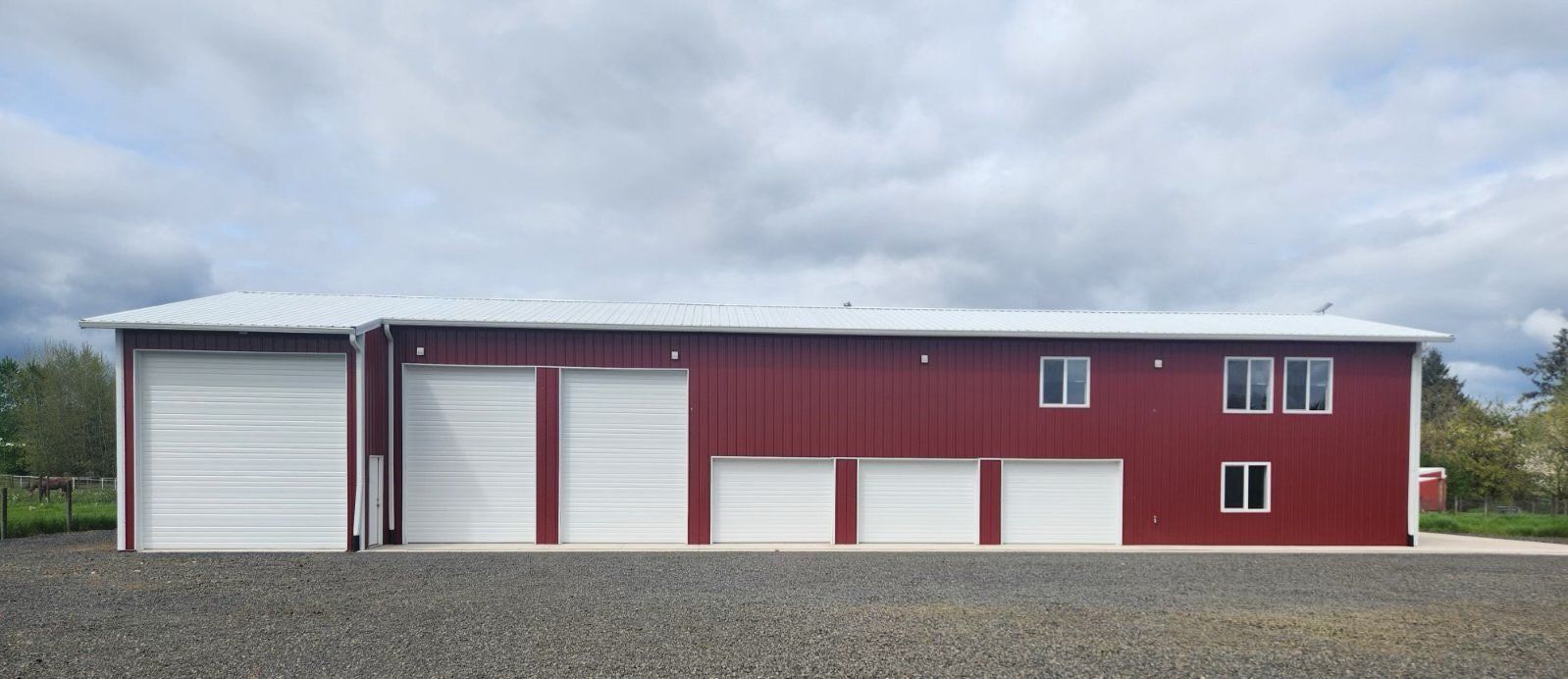 A large red building with white garage doors and windows