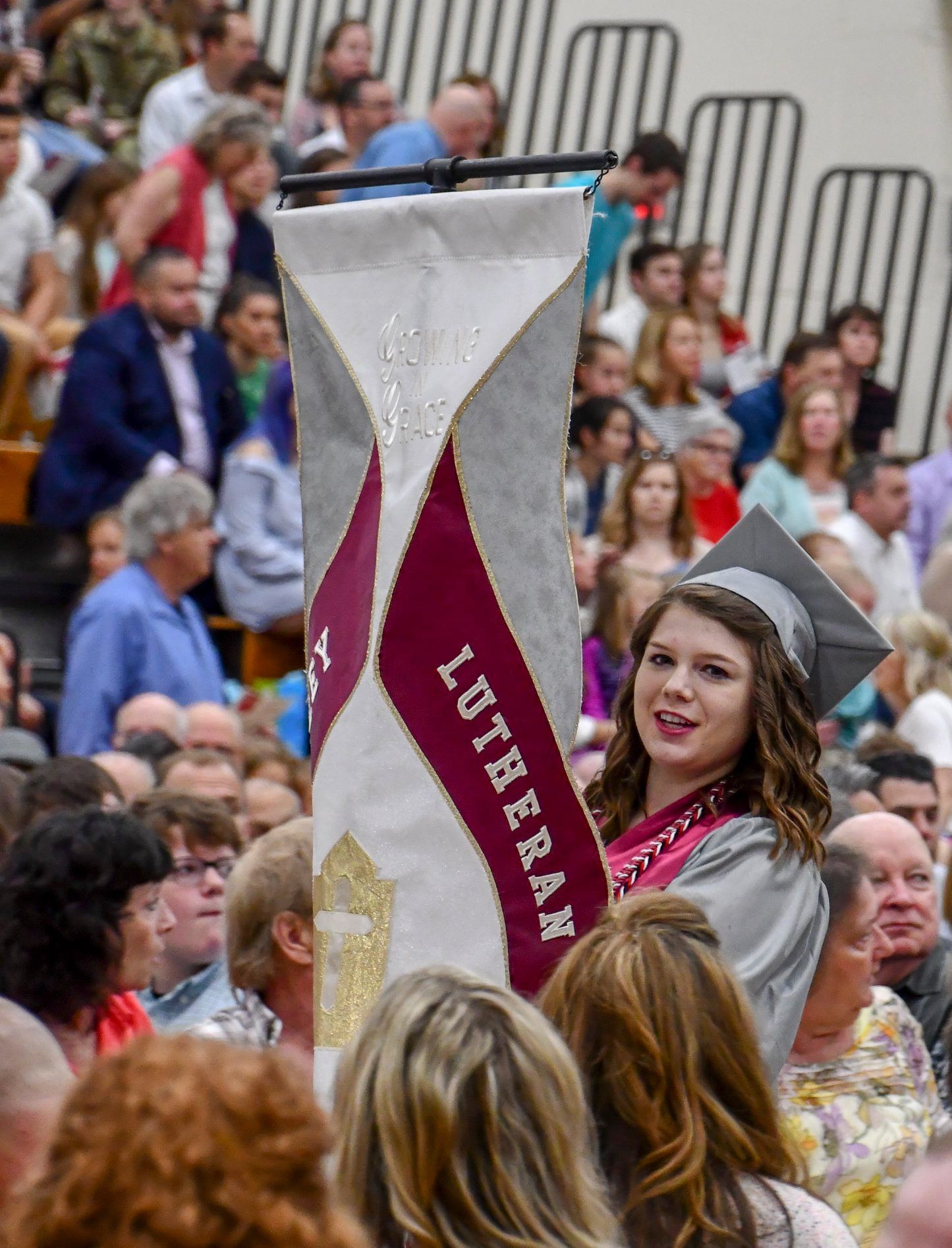 Procession for the FVL graduation service - class president carrying the banner