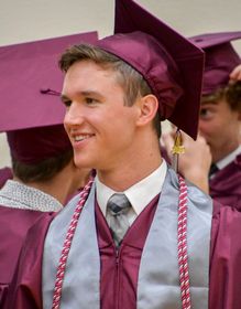 Smiling boy graduate on graduation day at Fox Valley Lutheran HS