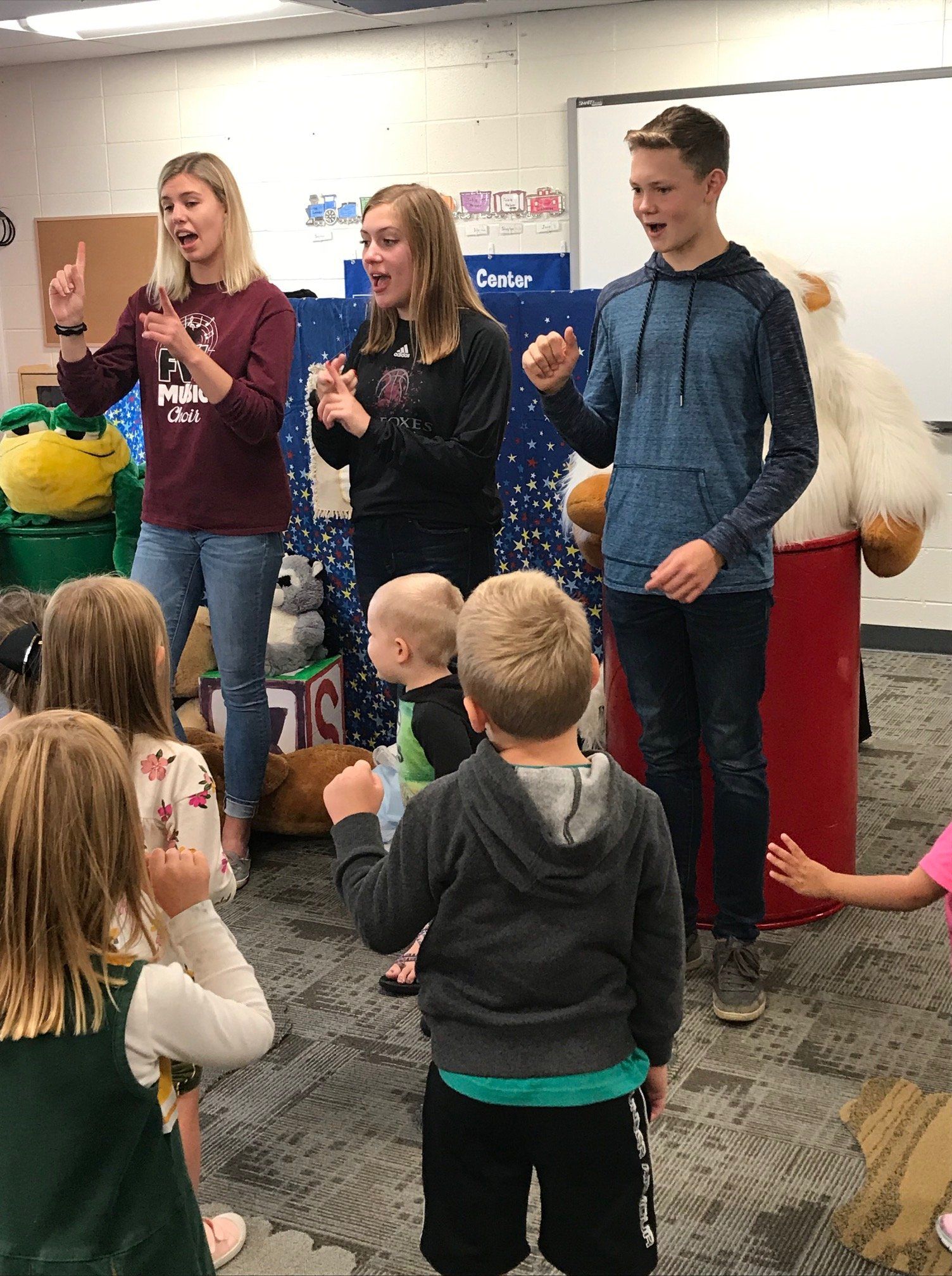 High school students visit preschoolers for some reading and activities