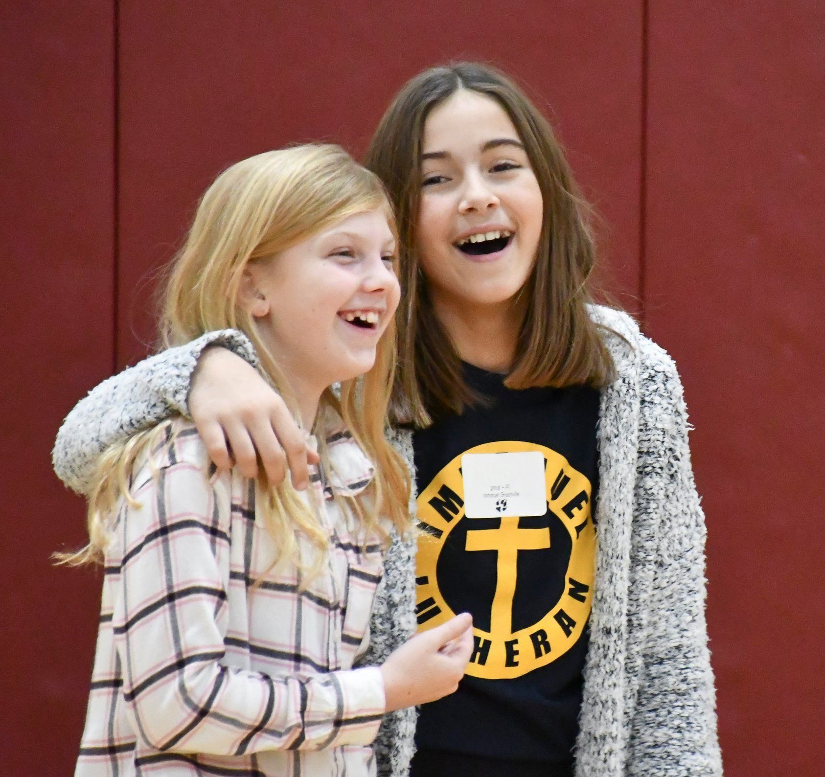 Two girls enjoying a laugh at an activity at the high school