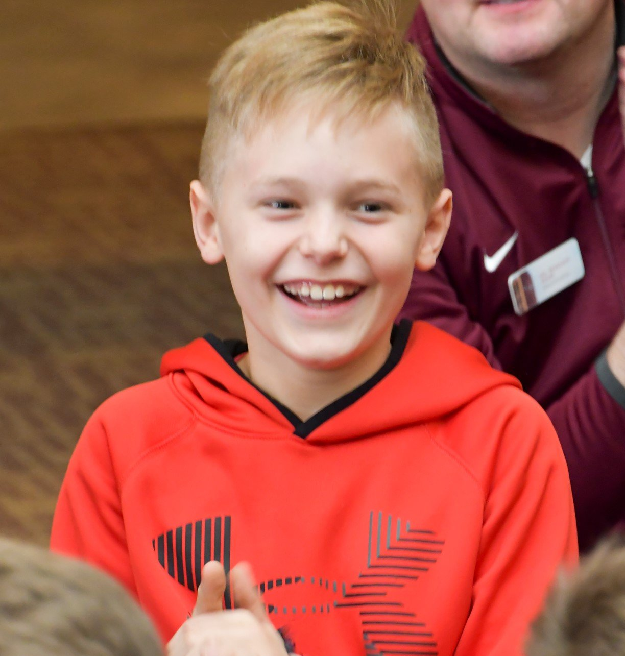 Laughing boy having fun with a group from the high school