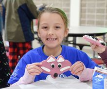 Foxhead cookie being displayed by 2nd grade girl