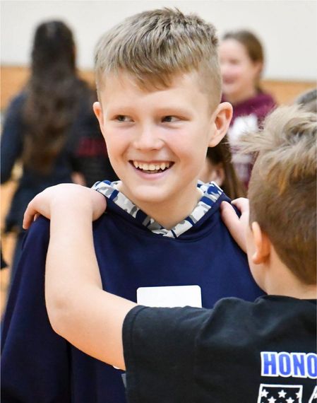 Smiling boy at a group activity in the FVLHS gym