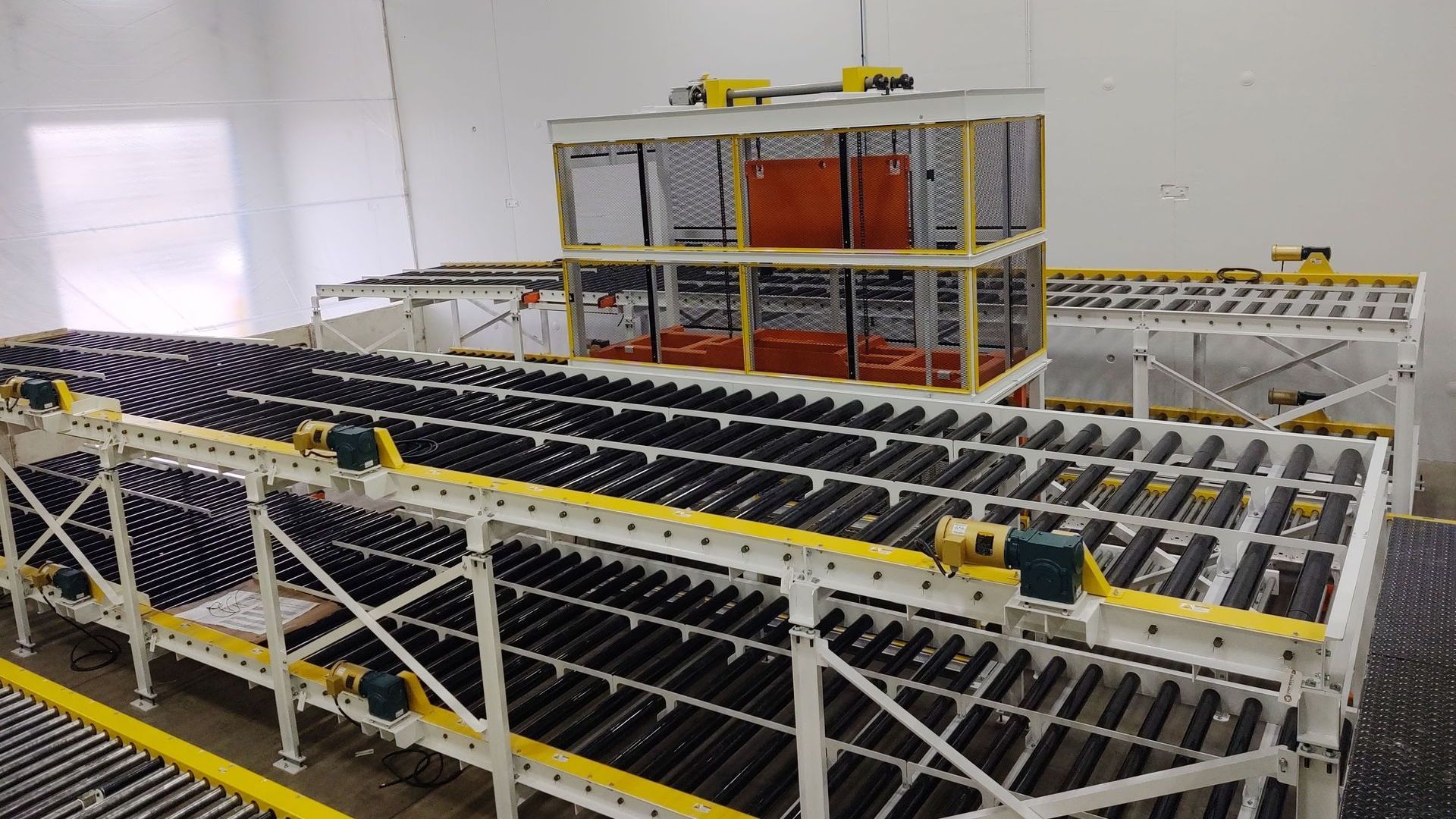 A conveyor belt filled with lots of bottles in a warehouse.