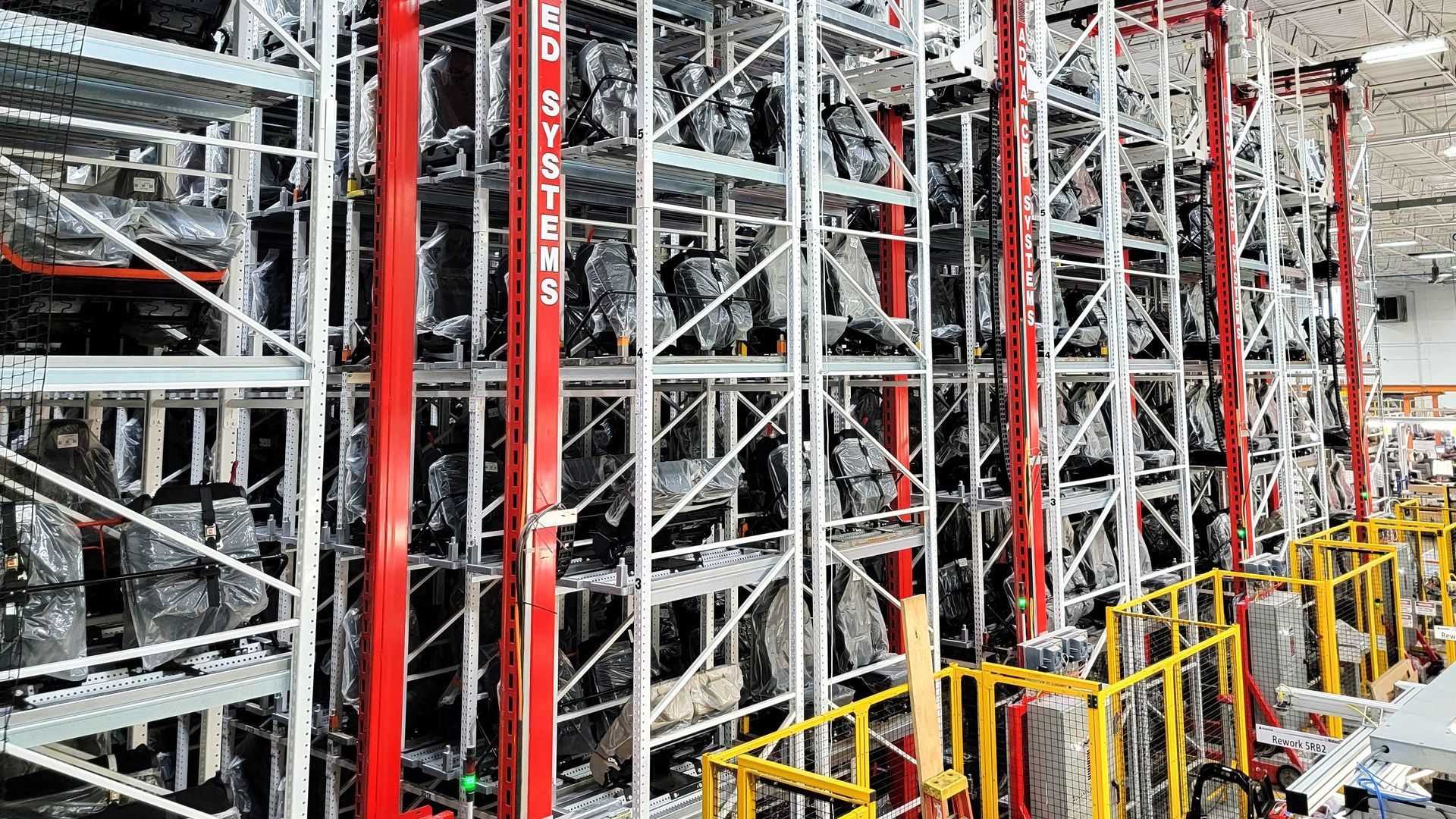 A large warehouse filled with lots of shelves and machinery.