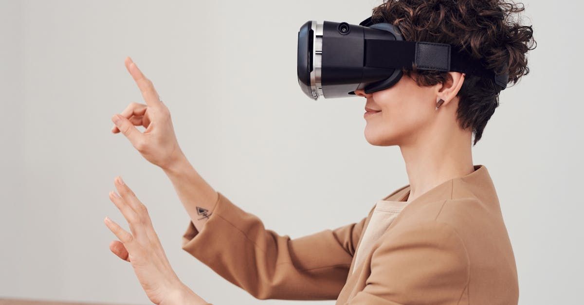 A woman is wearing a virtual reality headset and pointing at something.