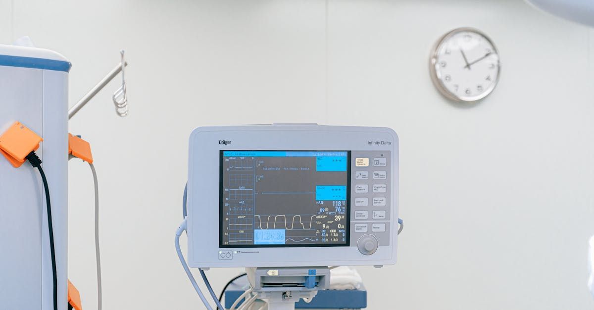 An operating room with a monitor and a clock on the wall.