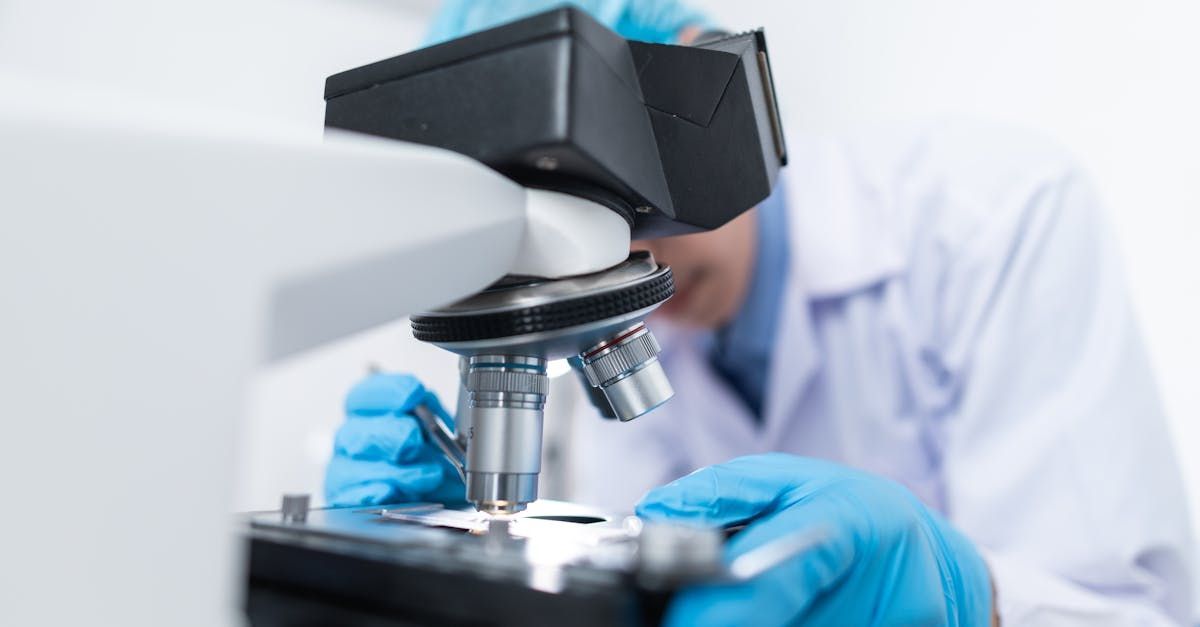 A scientist is looking through a microscope in a laboratory.