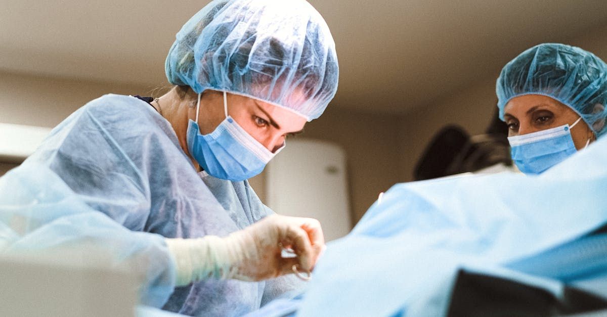 Two surgeons are operating on a patient in an operating room.